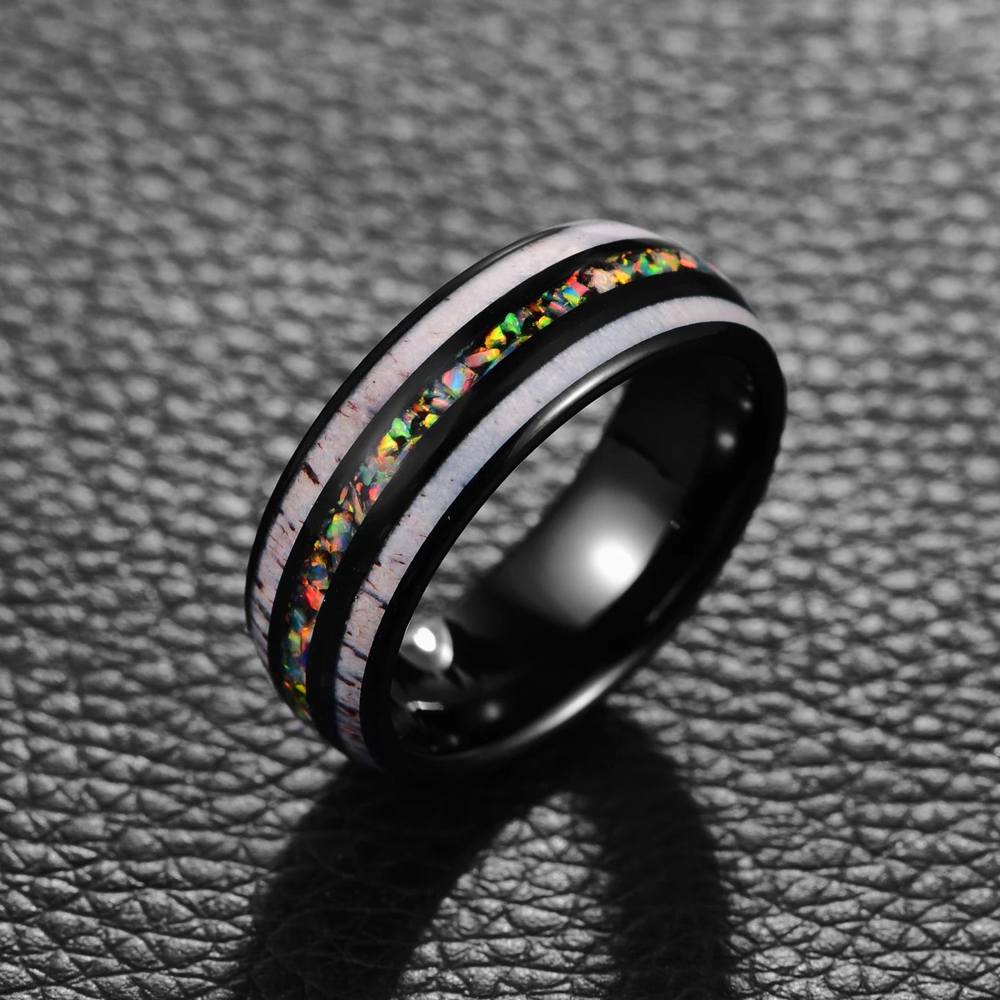 Black and opal ring, featuring a domed black Tungsten band inlaid with fiery opal and antler.