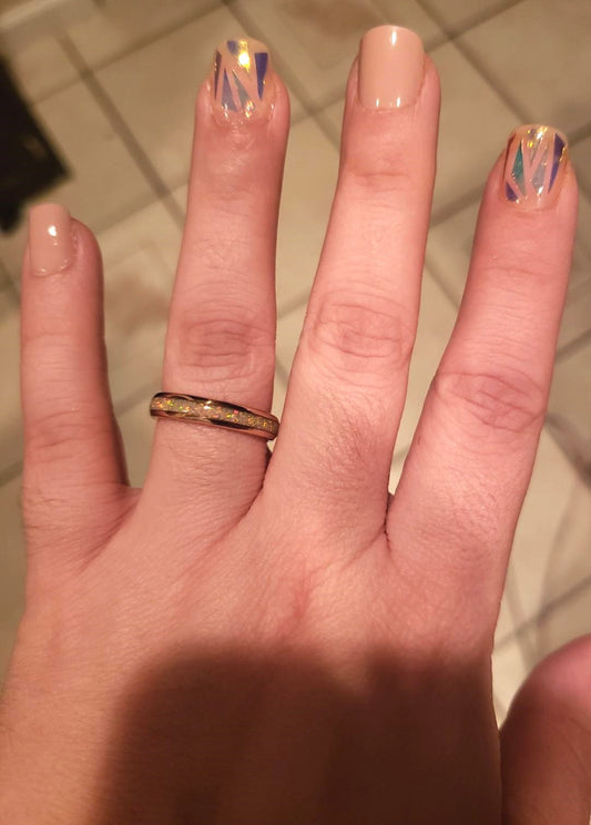 4mm rose gold Tungsten fire opal ring shown worn on finger, displaying the white fire opal inlay.