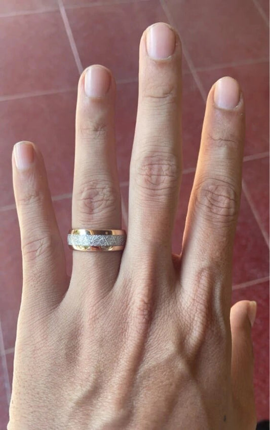 Mens rose gold meteorite ring with Gibeon meteorite inlay, worn on hand.