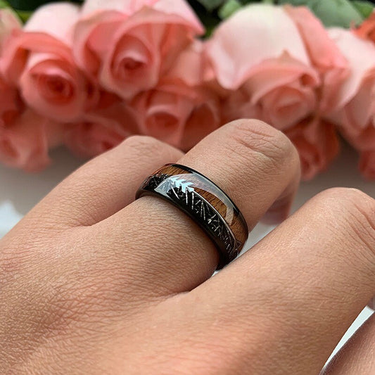 Wood and meteorite ring worn on hand, showcasing ebony wood and Gibeon meteorite inlay.