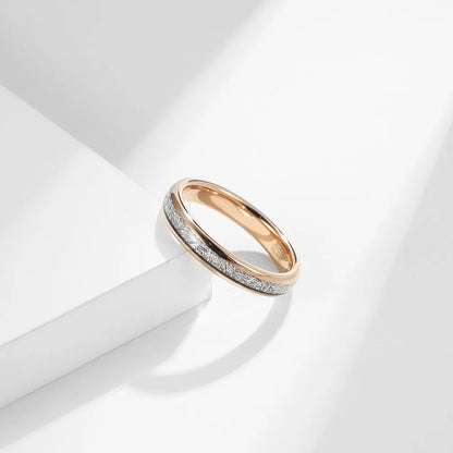 4mm rose gold Tungsten women's wedding band with meteorite inlay, photographed on a white surface.