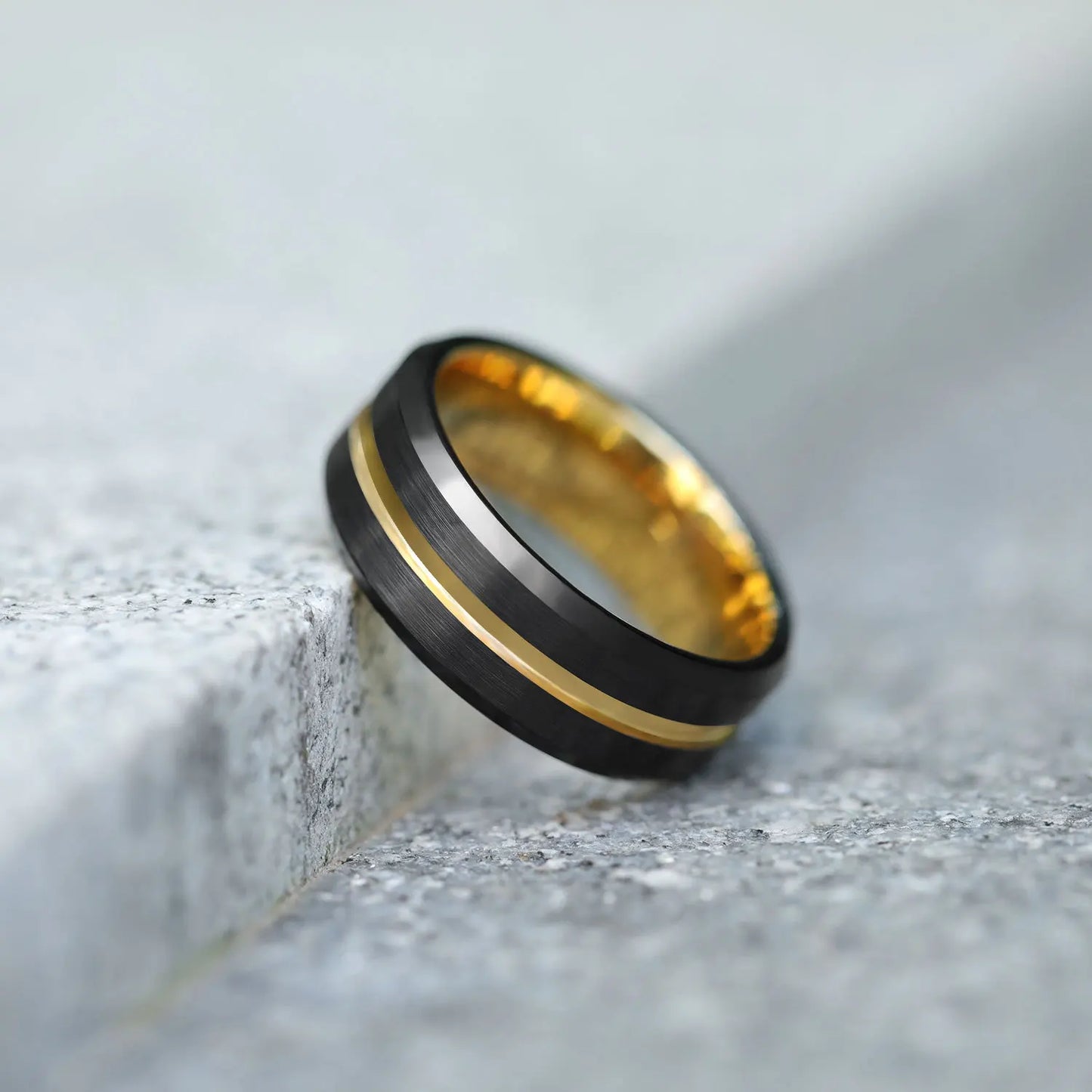 8mm black Tungsten ring with brushed exterior, polished beveled edges, and a gold stripe for a sleek and modern style.