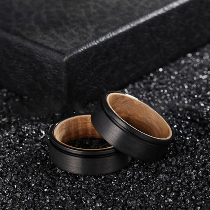 Set of black Tungsten rings featuring a natural olive wood interior, 8mm width.