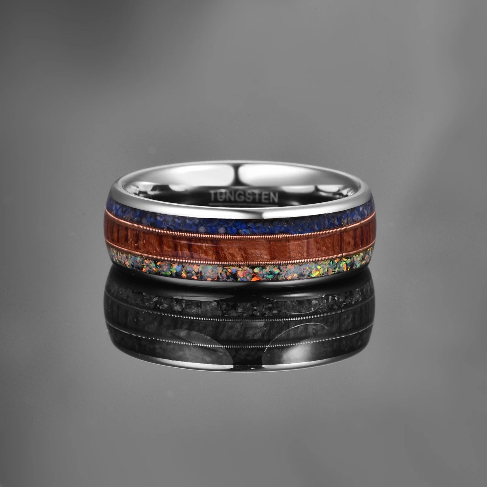 Domed silver Tungsten men's ring, 8mm wide, featuring inlays of crushed opal, lapis lazuli, and acacia wood, with rose gold guitar strings separating the inlays.