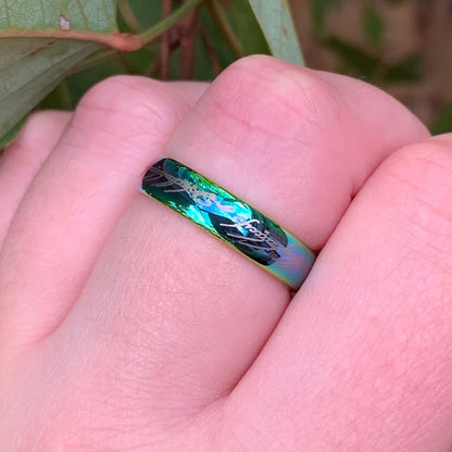 Lord of the Rings metallic green One Ring replica on finger outdoors