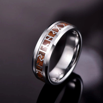 Viking rune ring in silver with a wood inlay on a black background