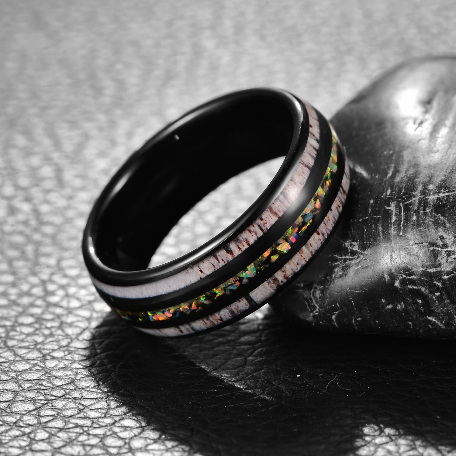 Black Tungsten men's ring with crushed opal and deer antler inlay, angled view