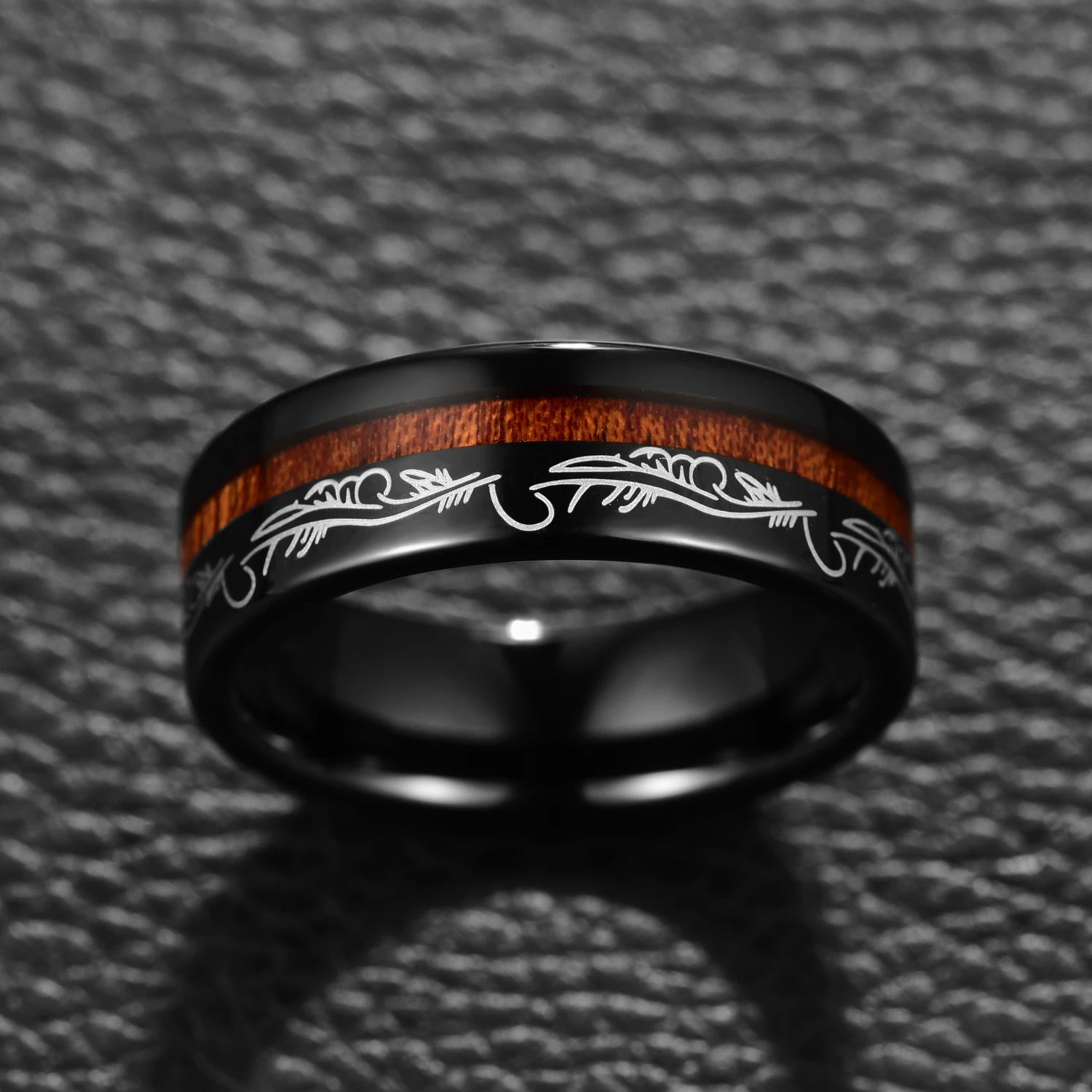 Black Tungsten ring with filigree feather detailing and offset acacia wood inlay, front view