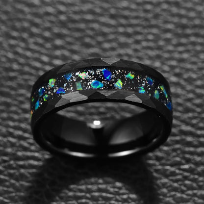 Close-up of black Tungsten ring featuring blue opal galaxy inlay, hammered edges, 8mm design