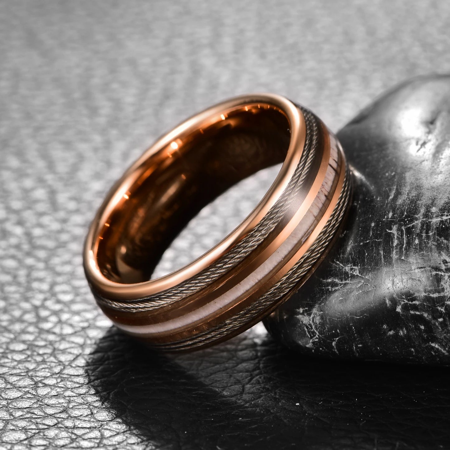 Close-up of rose gold Tungsten ring with antler and guitar string inlay, domed band