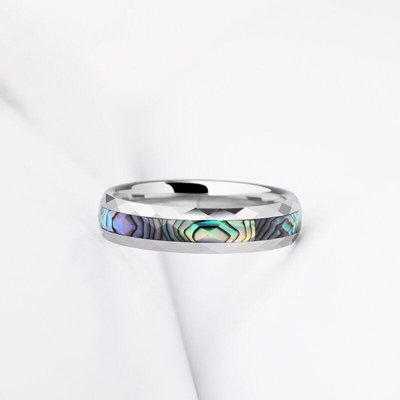 Faceted Tungsten ring with abalone shell inlay showcasing iridescent blue, green, and purple tones.