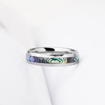 Faceted Tungsten ring with abalone shell inlay showcasing iridescent blue, green, and purple tones.