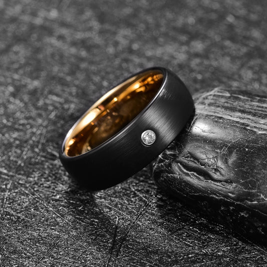 Side view of gold and black Tungsten men’s ring with flush-set cubic zirconia stone, featuring a brushed finish and domed design