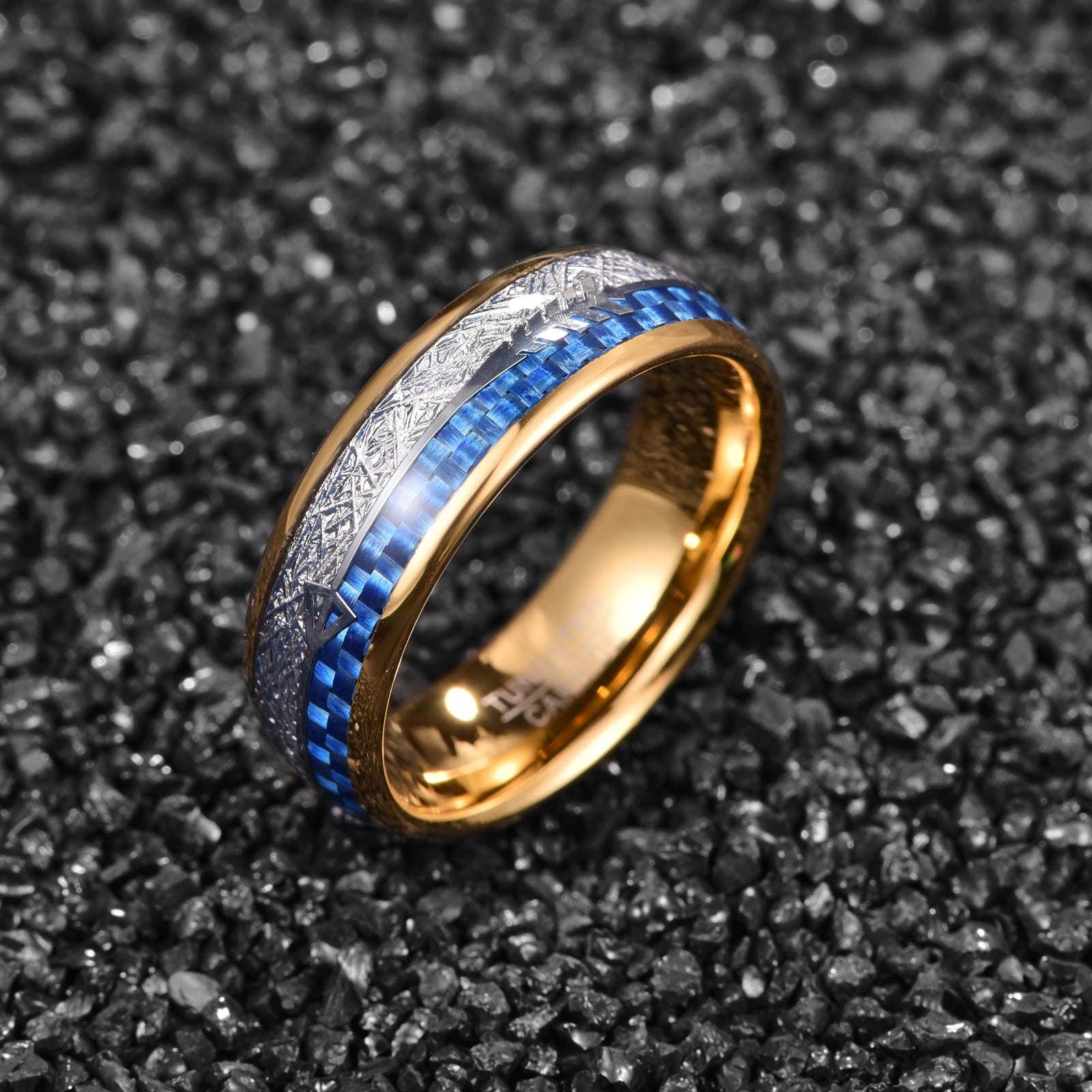 Angled view of a gold tungsten ring with meteorite and blue carbon fiber inlay featuring an arrow design