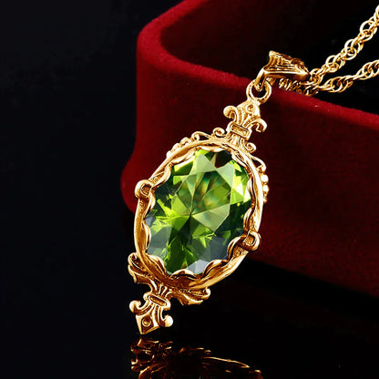 Gold Victorian style filigree pendant set with natural green peridot stone.