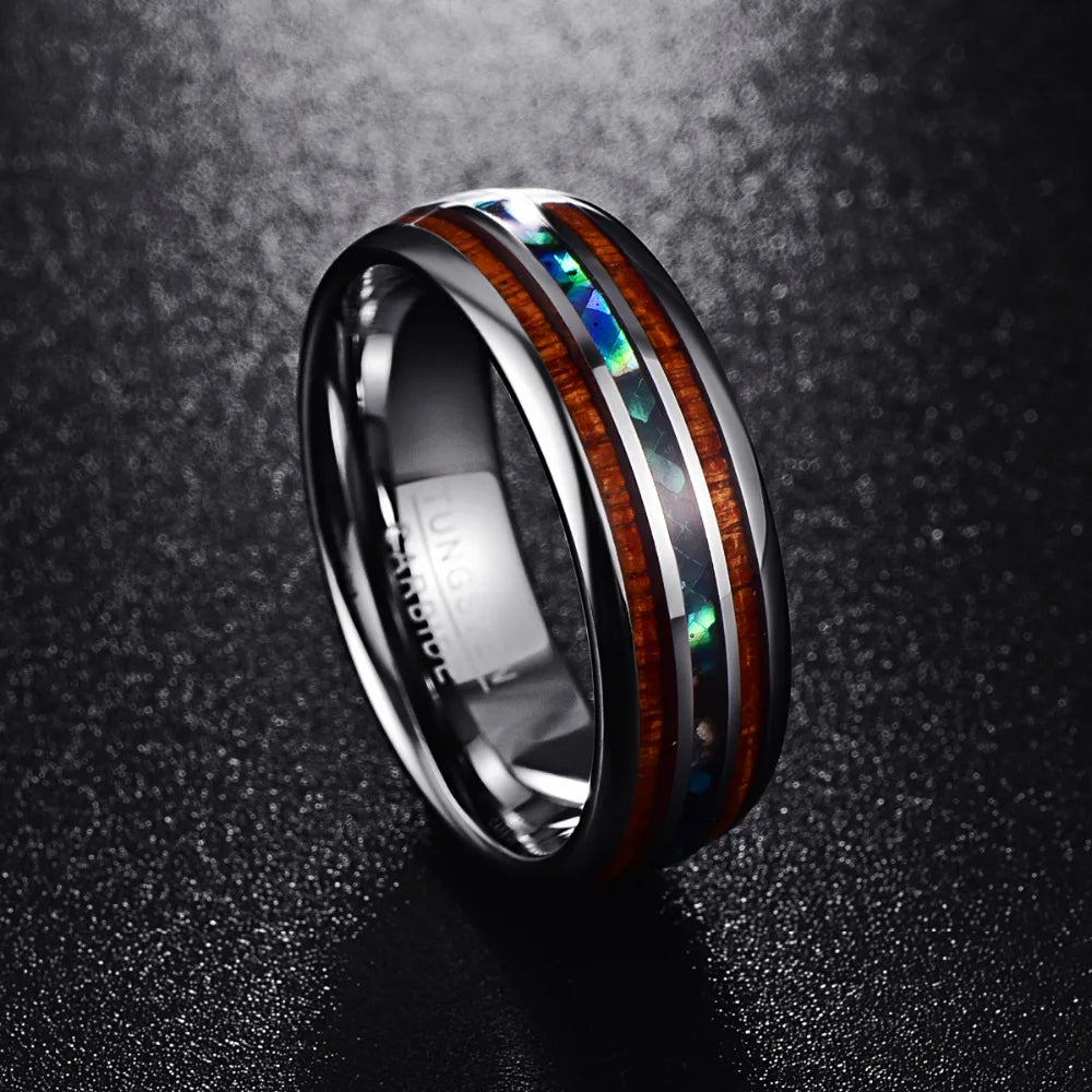 Koa wood rings, showcasing strength and resilience, with abalone shell inlay.