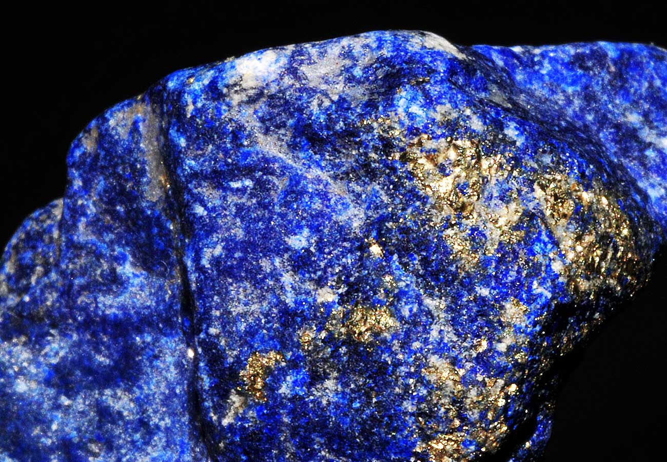 Close-up of Lapis Lazuli stone, displaying rich blue color with golden flecks of Pyrite.