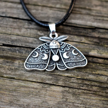 Moonlit moth charm with intricate wing texture and celestial details inspired by the night sky.