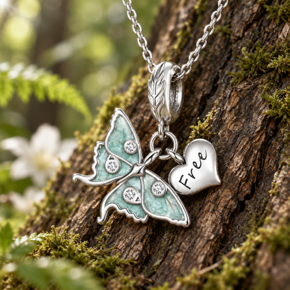 Moth jewelry inspired by the luna moth, with delicate green wings and cubic zirconia accents.