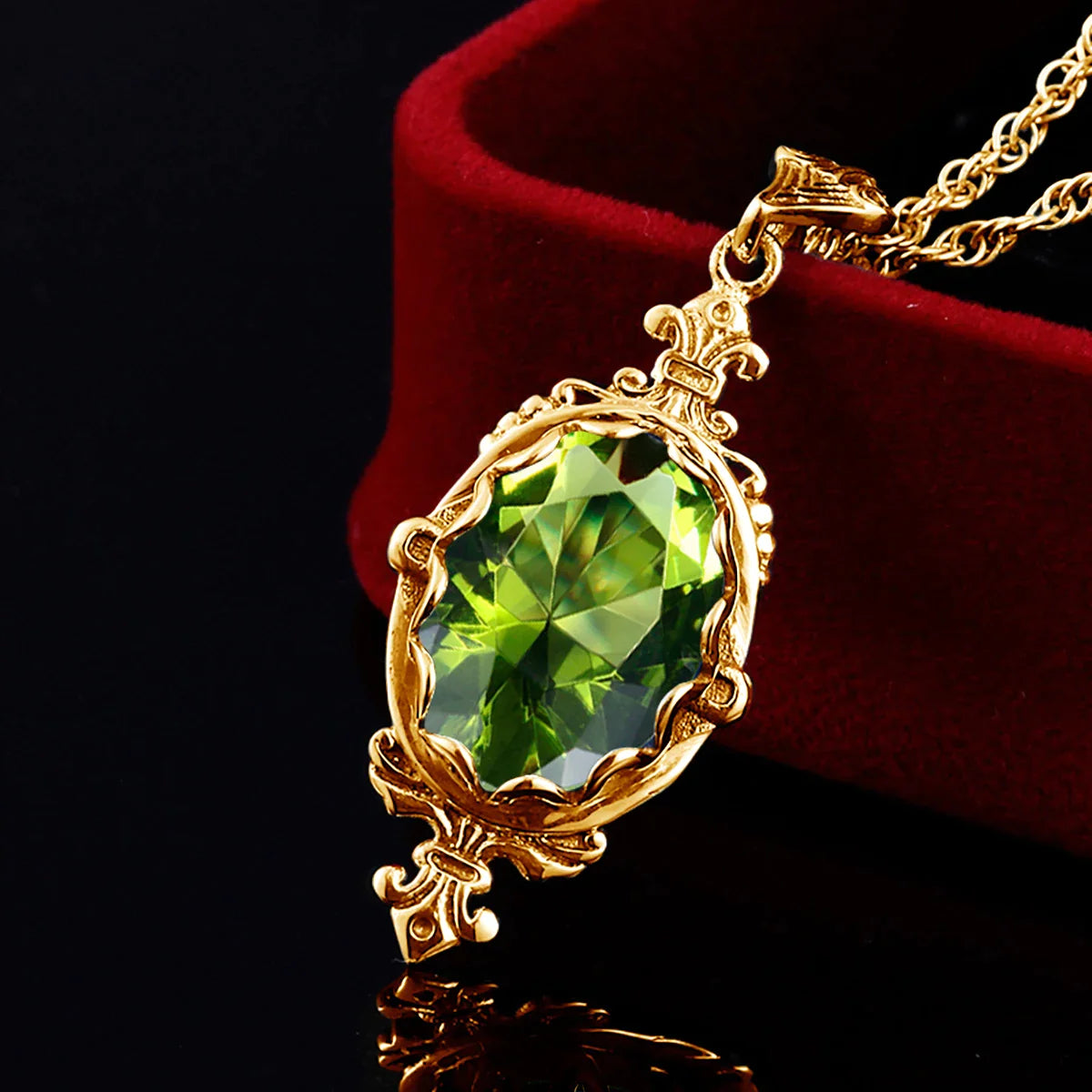 Ornate yellow gold pendant with a vivid oval peridot jewel and antique-style detailing.