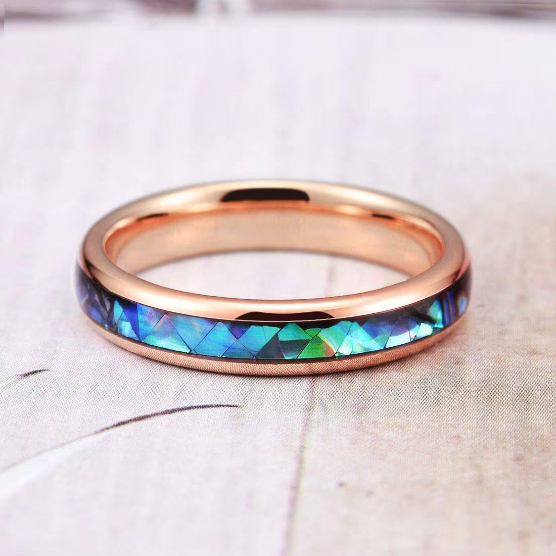 Rose gold Tungsten ring with an oceanic abalone shell inlay that shimmers in colorful hues.