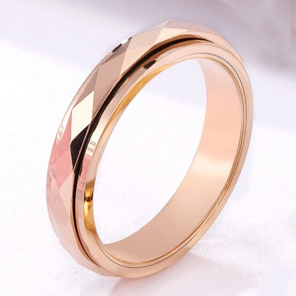 Rose gold fidget ring, with a faceted spinner set in a polished band for a sleek, elegant look.