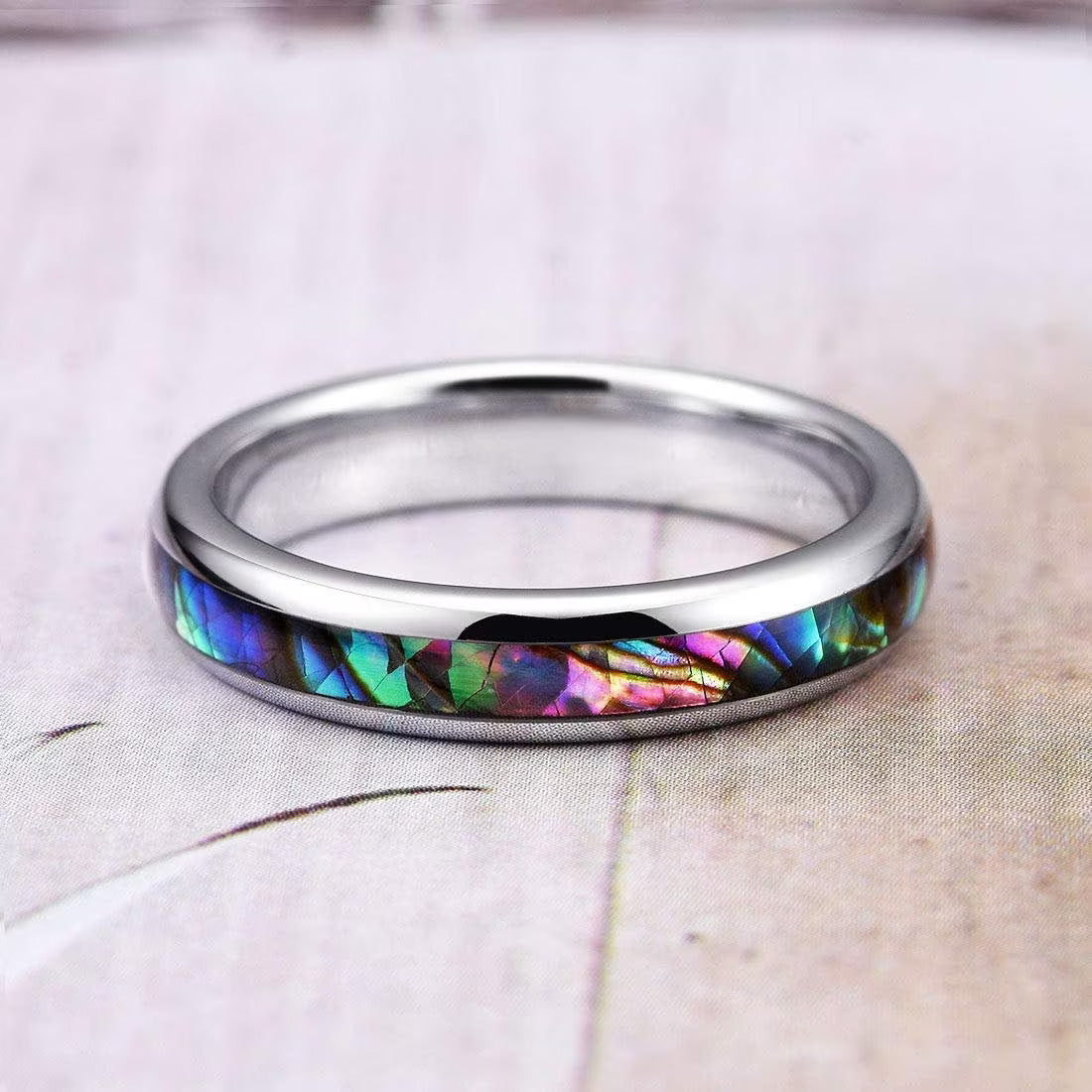 Silver Tungsten ring with a vibrant abalone shell inlay, showcasing shimmering ocean tones.