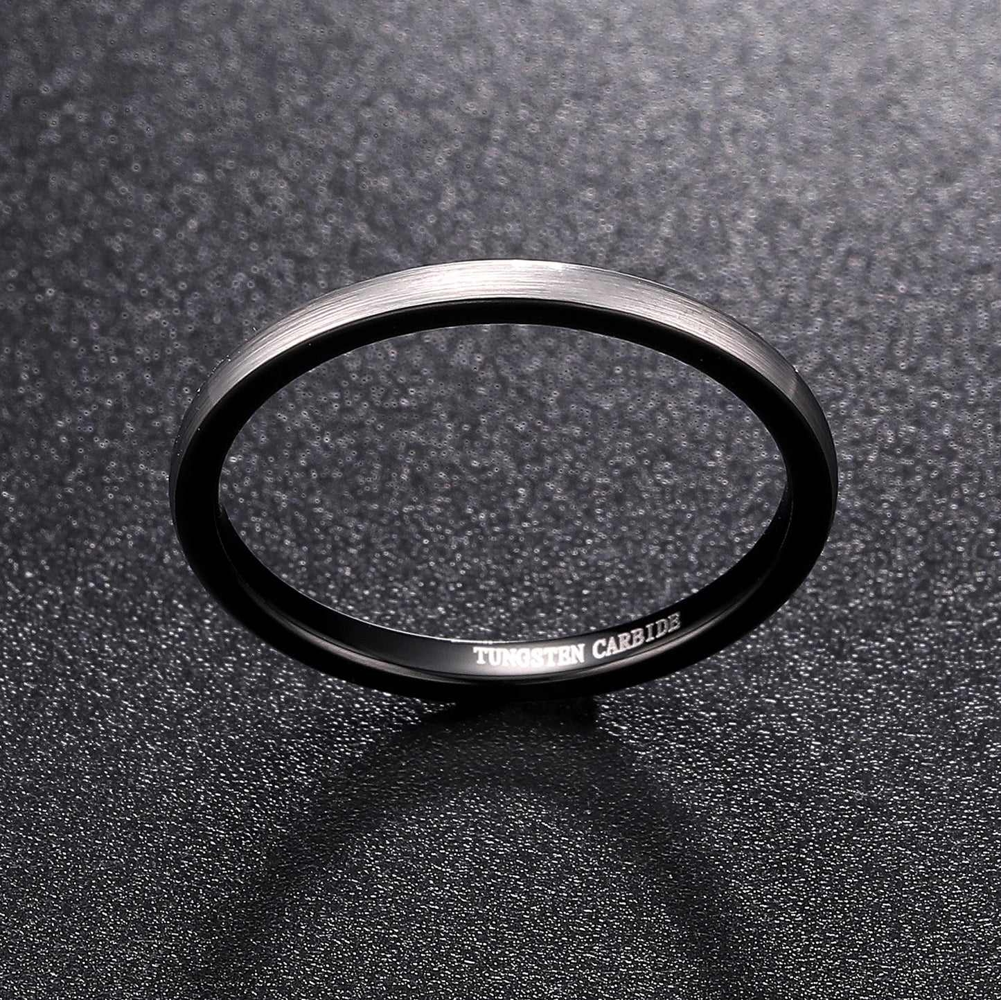 Silver and black rings, featuring a narrow feminine domed design.