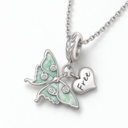 Sterling silver luna moth necklace on a white background, hanging from a silver chain.