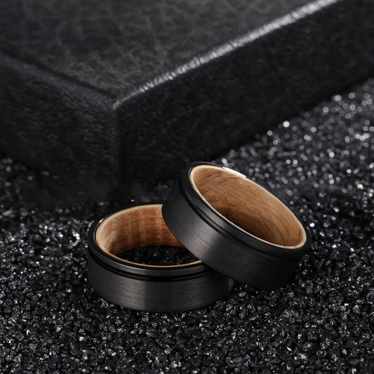 Wood ring with a genuine natural olive wood interior set in black Tungsten.
