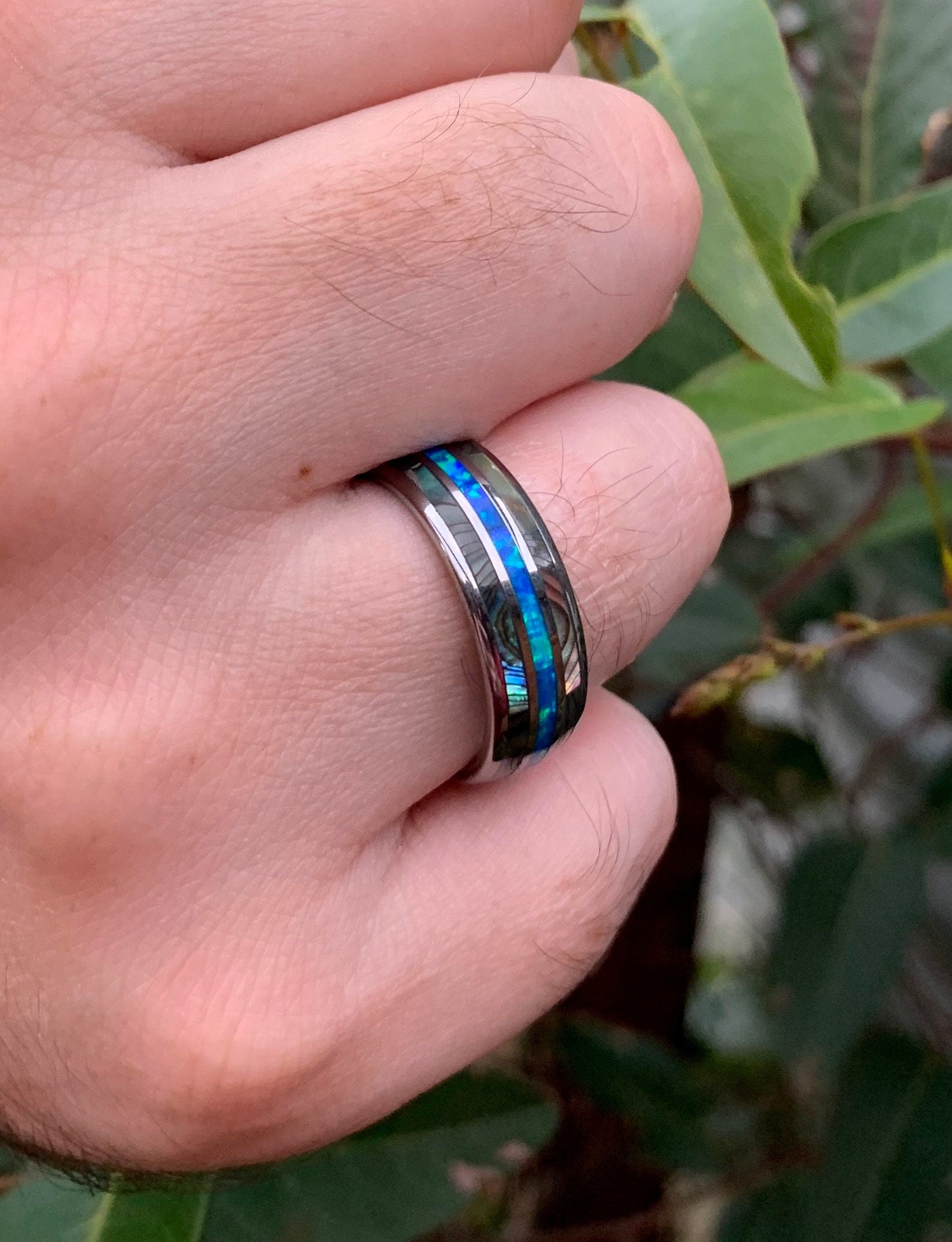 Abalone shell ring with natural opal inlay in blue and green hues.