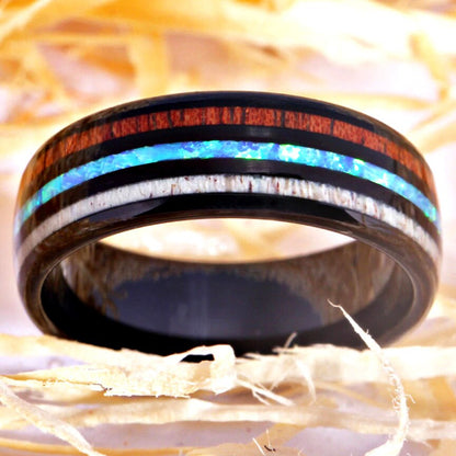 Antler rings for him with a black Tungsten band and inlays of wood, antler, and opal.