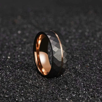 Black Tungsten faceted ring with a rose gold stripe and polished rose gold interior.