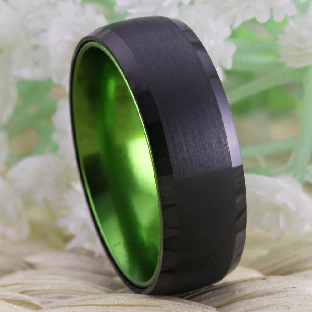 Black and green wedding rings with black Tungsten band and bright green interior.