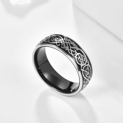 Black dragon ring with a domed Tungsten band, silver edges, and Celtic dragon pattern.