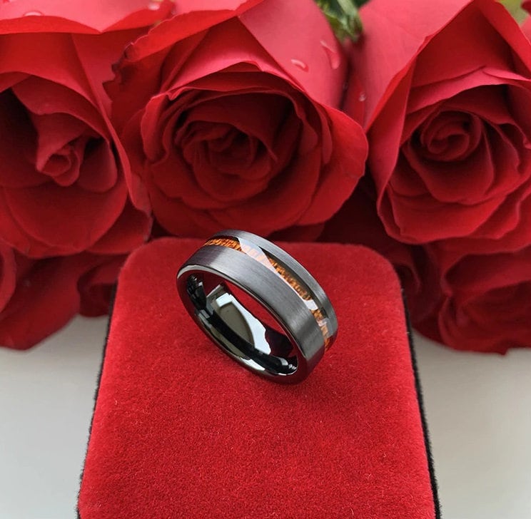 Black wooden wedding rings with a black Tungsten exterior and Sapele wood inlay.