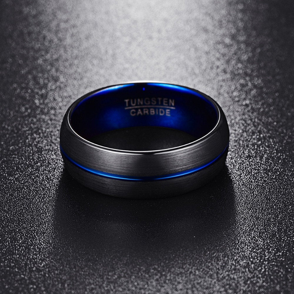 Blue wedding bands for him with a black exterior, and polished blue interior and stripe.