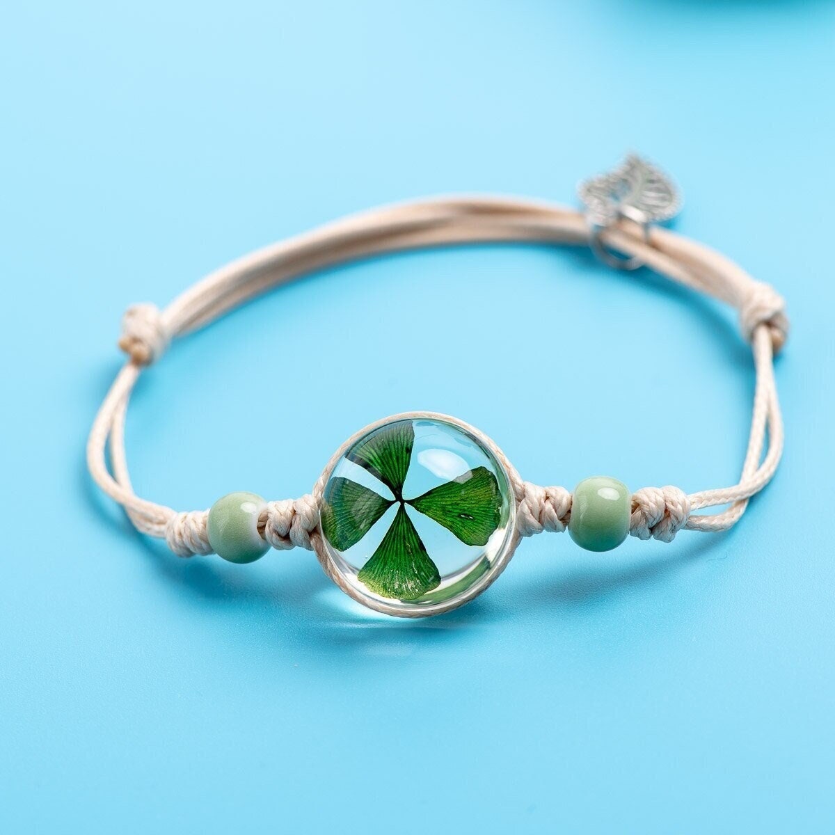Close-up of a botanical bracelet with a genuine preserved specimen set in a round glass setting.
