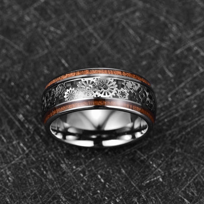 Cogwheel ring featuring silver gears over black carbon fiber with koa wood, 10mm.