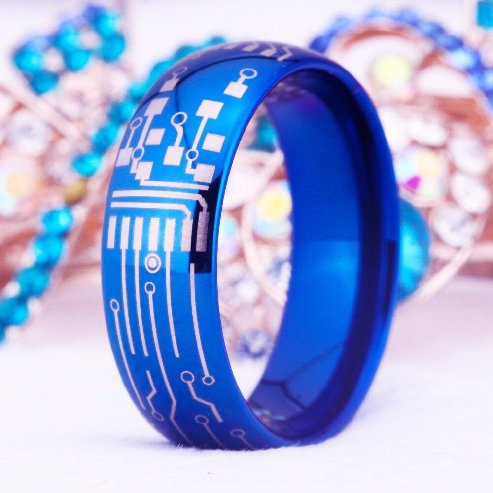 Computer chip jewelry in a blue Tungsten men’s ring with circuit board engraving.