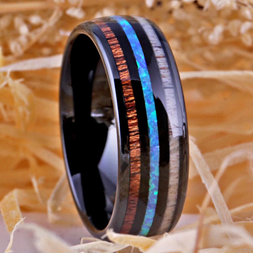 Deer antler jewelry crafted with a Tungsten band inlaid with wood, opal, and antler.