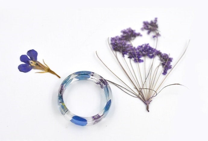 Nature-inspired resin ring made with two different types of dried flowers.