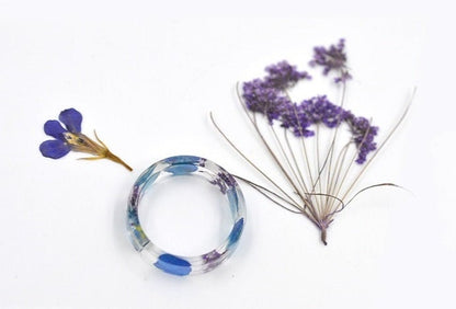 Nature-inspired resin ring made with two different types of dried flowers.