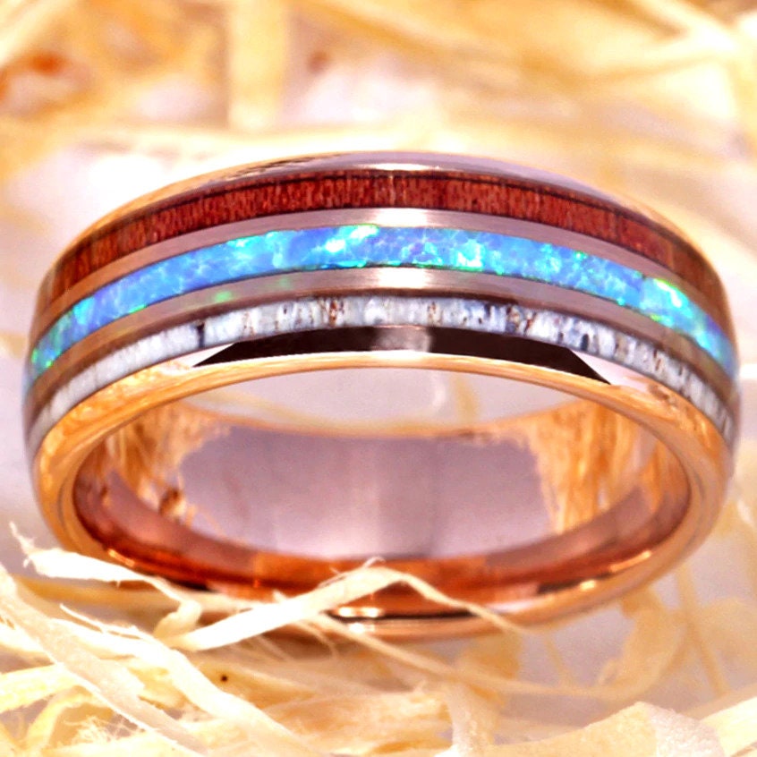 Elk antler wedding ring crafted from rose gold Tungsten with opal and antler inlays.