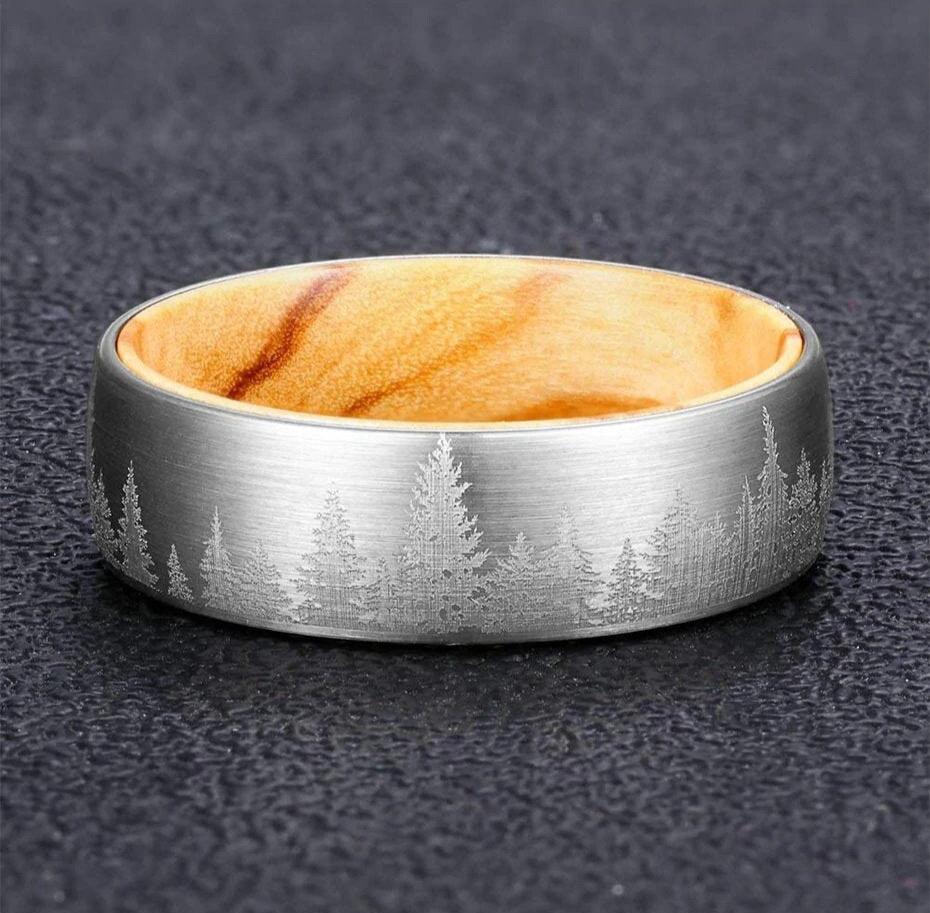 Forest in a ring crafted with a silver Tungsten band and pine wood interior.