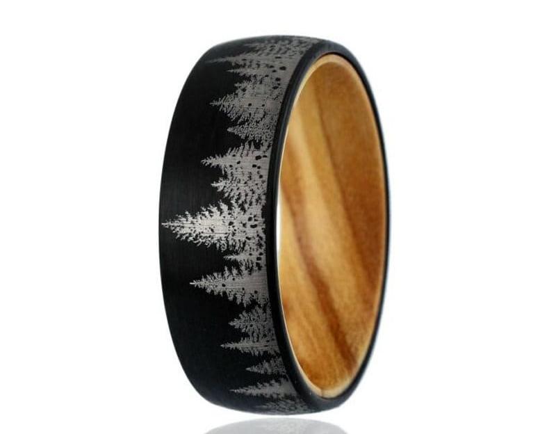 Forest ring with a black Tungsten exterior and smooth pine wood interior.