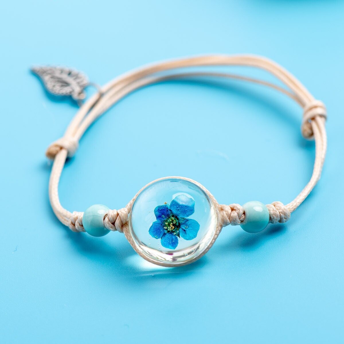 Forget me not bracelet with a real flower inside clear glass.