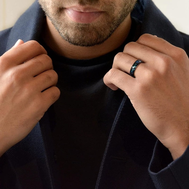 Galaxy inlay mens ring with a 6mm black Tungsten band and vibrant cosmic inlay, shown on man's hand.