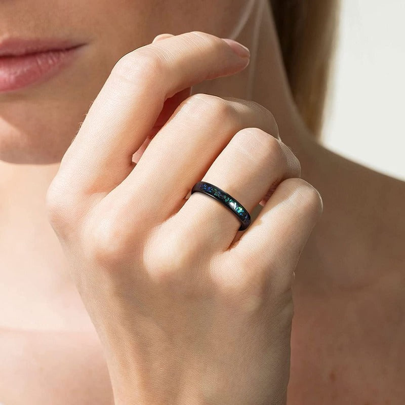 Galaxy inlay women's ring with a black Tungsten band, shown on a woman's hand.