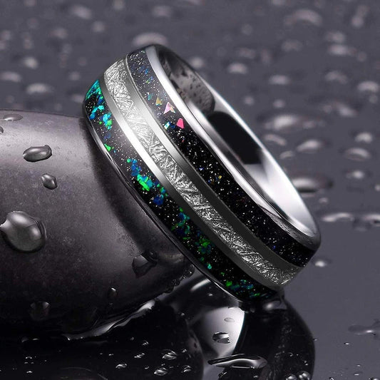 Galaxy inspired wedding rings featuring crushed black sandstone and meteorite inlay.